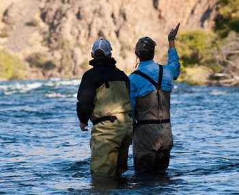 An angler getting a fly fishing lesson on the Deschutes